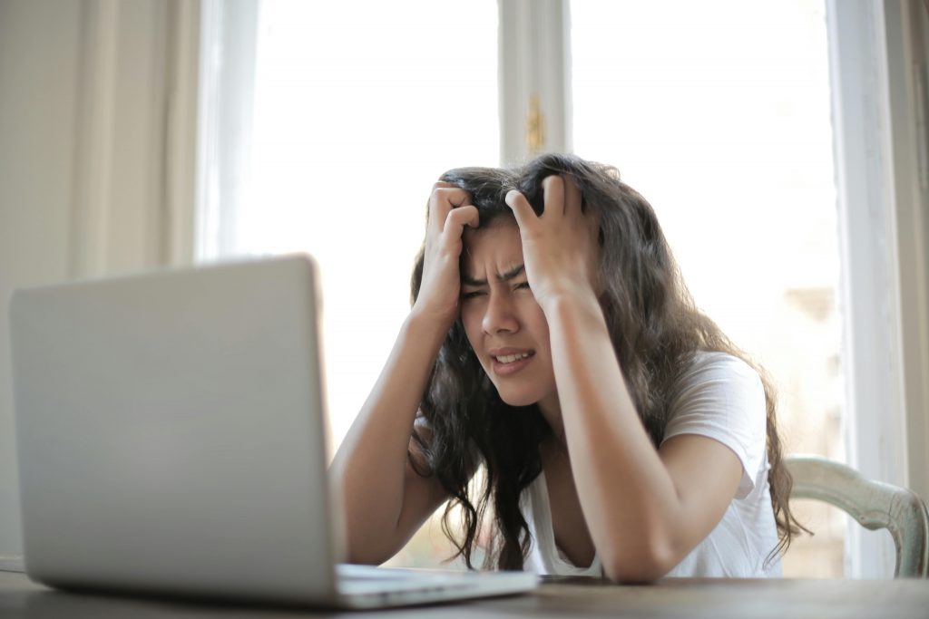 A woman frustrated wasting time on unwanted email