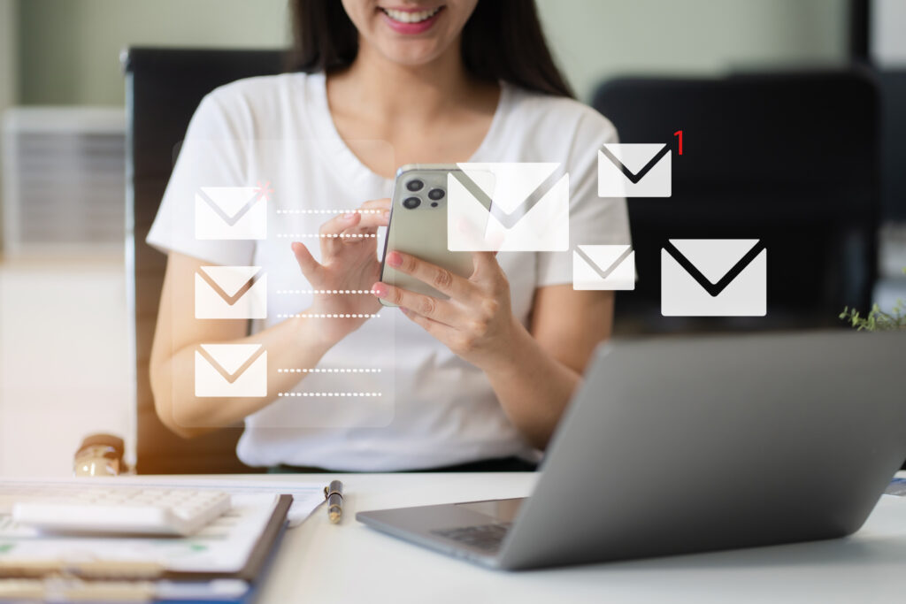 Email notification concept, Female use smartphone and laptop receive message alert in the mailbox.