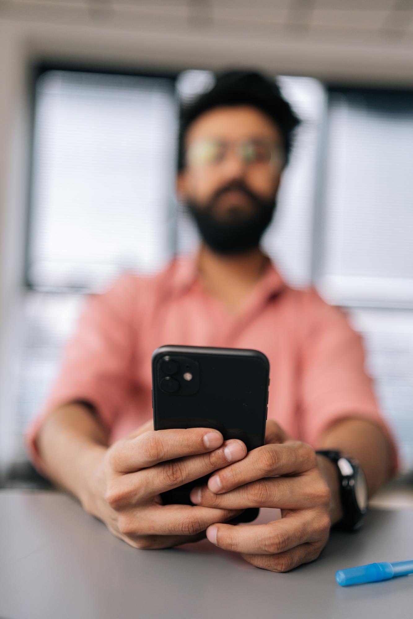 Vertical selective focus shot of blurred bearded m